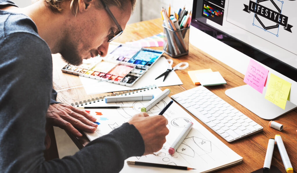 young talented graphic designer creating logos at his desk